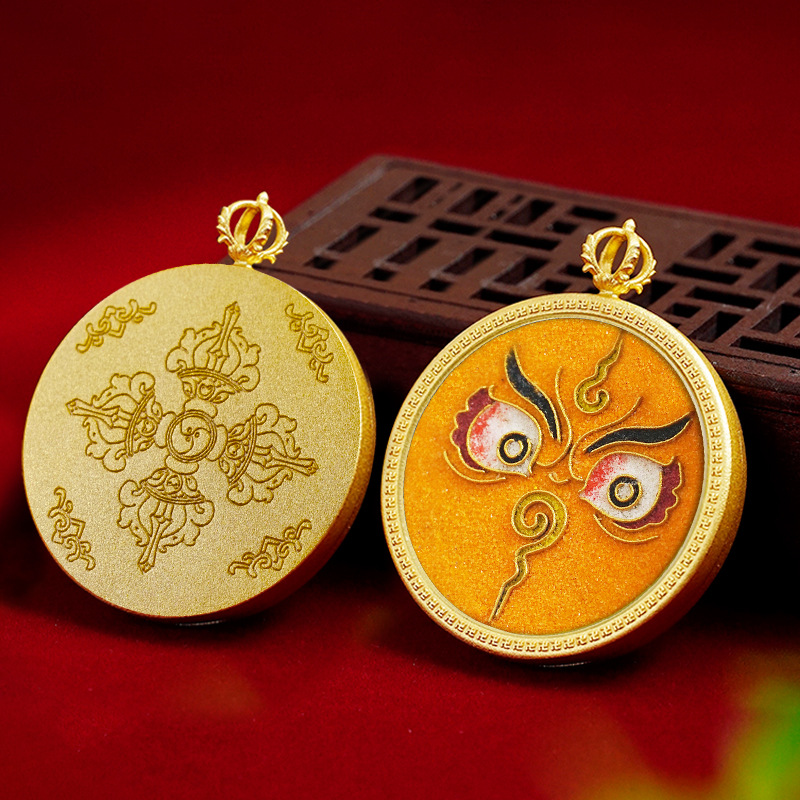 Two gold pendants with intricate designs on a red background