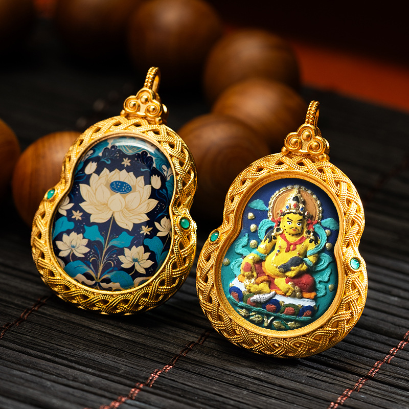 Two ornate pendants on a dark surface with a blurred background