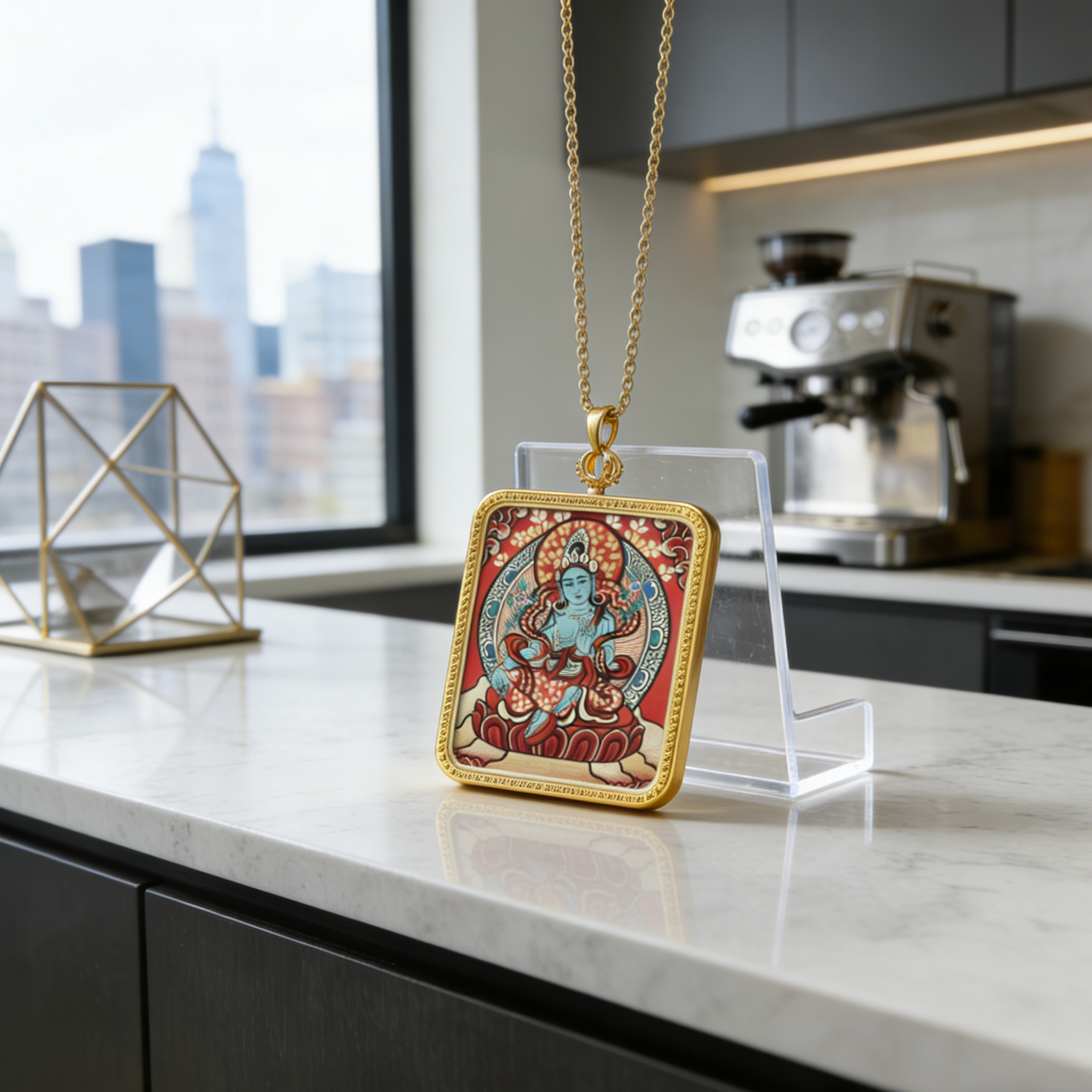 Decorative pendant on a chain displayed on a stand in a modern kitchen.