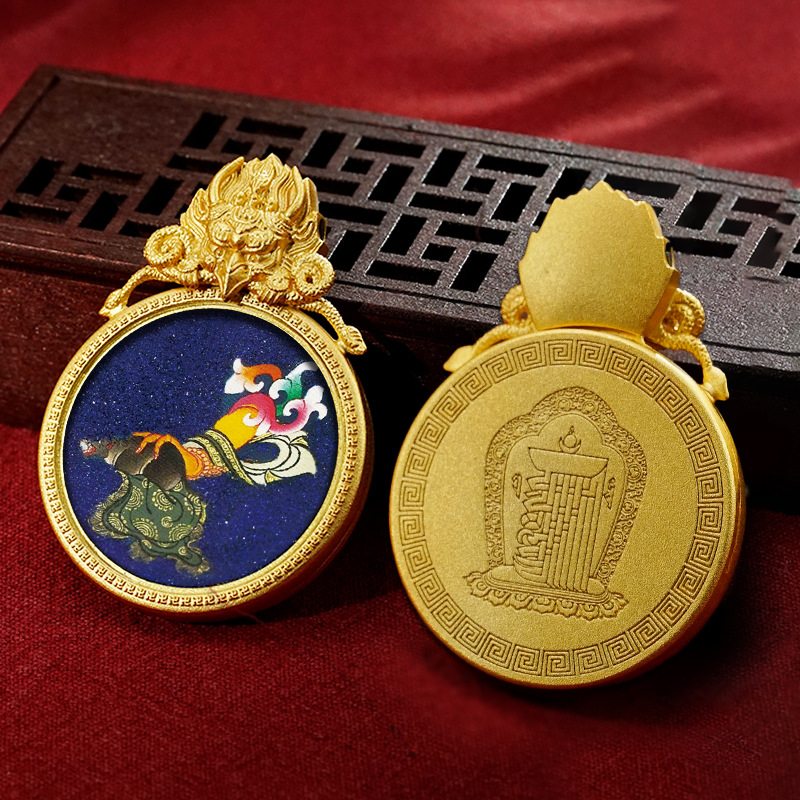 Gold pendant with intricate design on a red fabric background